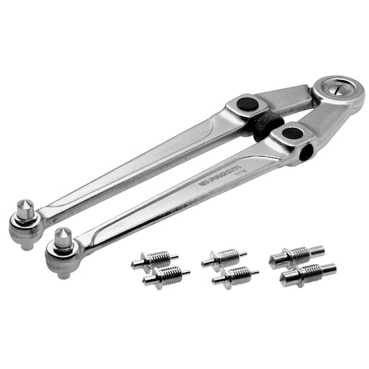 Photo of Facom 117_B adjustable silver caliper divider with six steel attachments, angled on white background.