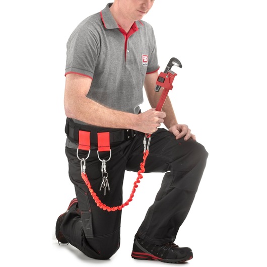 Facom tool tether kit SKU 131A_24SLS attached to wrench and keys, worn by worker on white background, side view.