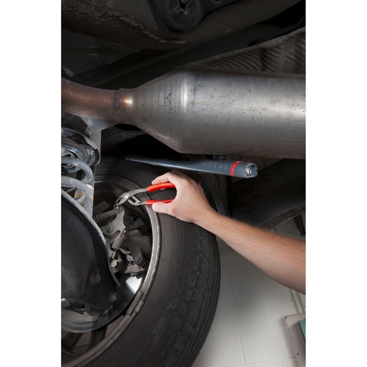 Facom 170A_18 pliers in use on car wheel suspension, close-up photography.