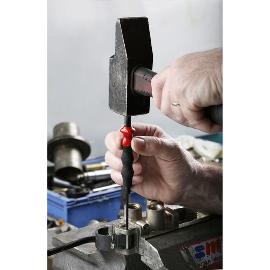 Facom 249_G4 screwdriver with black and red handle used in workshop setting, close-up photography.