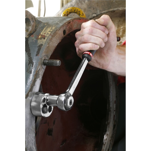 Facom 286A ratchet wrench in use, showing chrome finish and ergonomic handle near machinery.