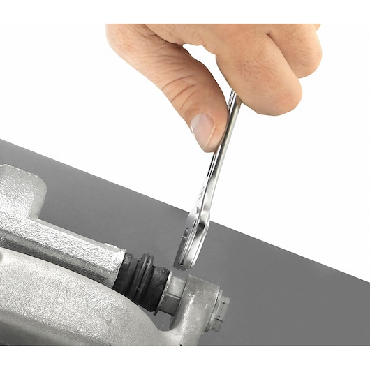 Facom 440_13 combination wrench being used on metal fitting, close-up photo.