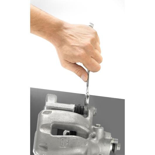 Facom 440_19 chrome wrench in hand tightening bolt on automotive part, side angle, photography.