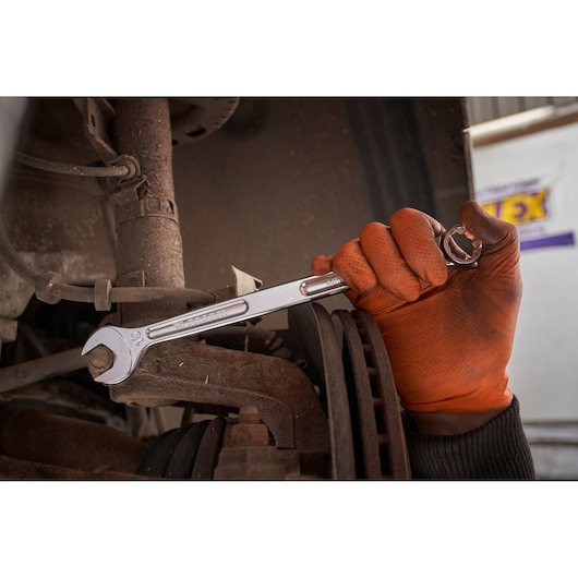 Facom 440XL_19 wrench in use on car part, held by gloved hand, automotive repair scene.