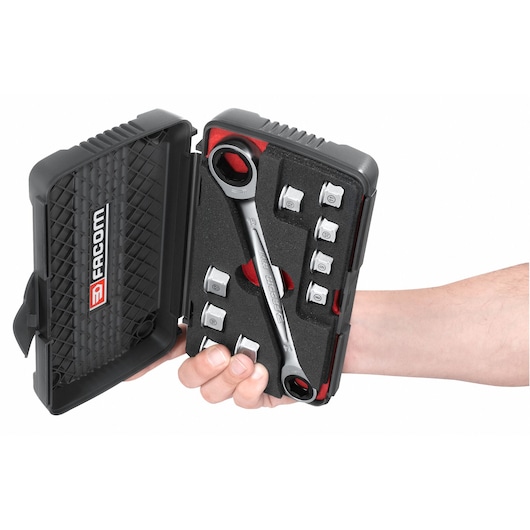 Facom 464J1 ratcheting wrench and socket set in black case, hand holding kit, photo from above.