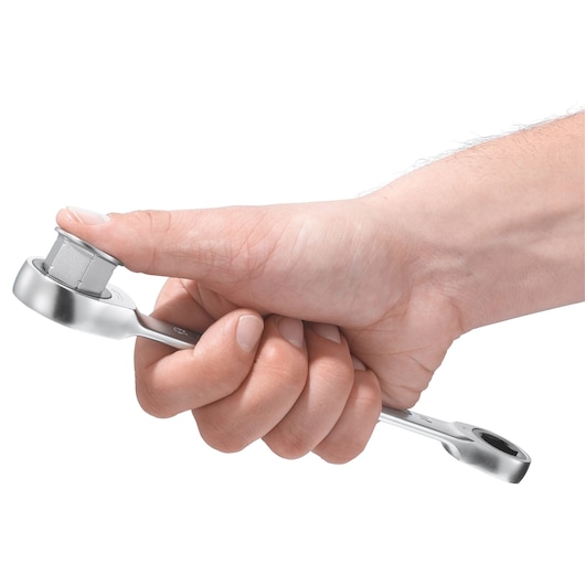 Facom 464J1 ratchet spanner held in hand, showcasing chrome finish and socket, white background.
