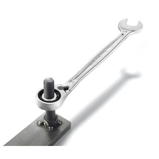 Facom 467B.11PB ratcheting wrench in use on a bolt, silver finish, photography, angled view.