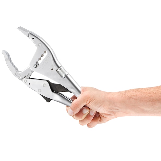 Facom 501A locking pliers with serrated jaws held in a right hand, side angle on white background.