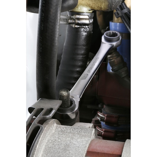 Photo of Facom 64C_J2PB ratcheting combination wrench tightening a bolt in an engine compartment.