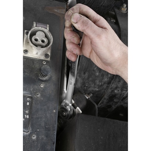 Photo of Facom ratcheting wrench, SKU 64C_S2, used on machinery in a close-up hand operation.