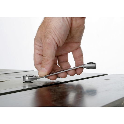 Photo of hand using Facom 65PE ratcheting spanner on a metal surface.