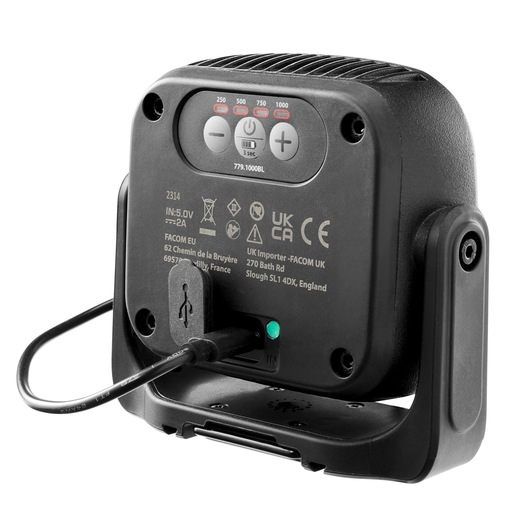 Facom 779.1000BLPB work light rear view showing charging cable connected, control buttons, and certification markings.