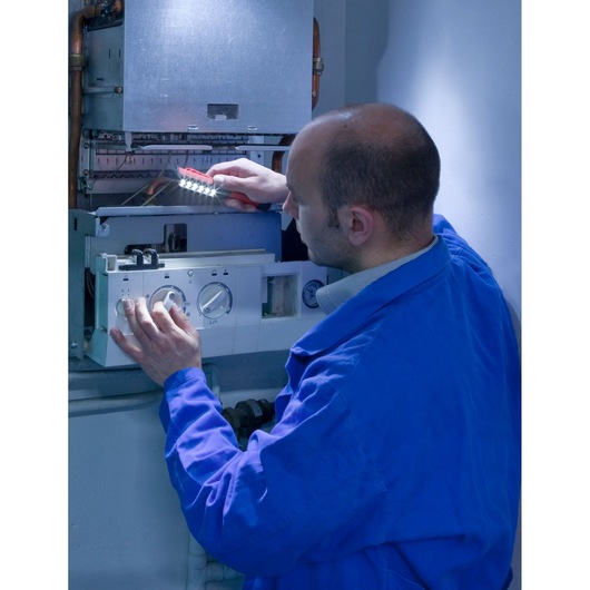 Facom 779.PENPB photography of technician inspecting boiler with LED work light.