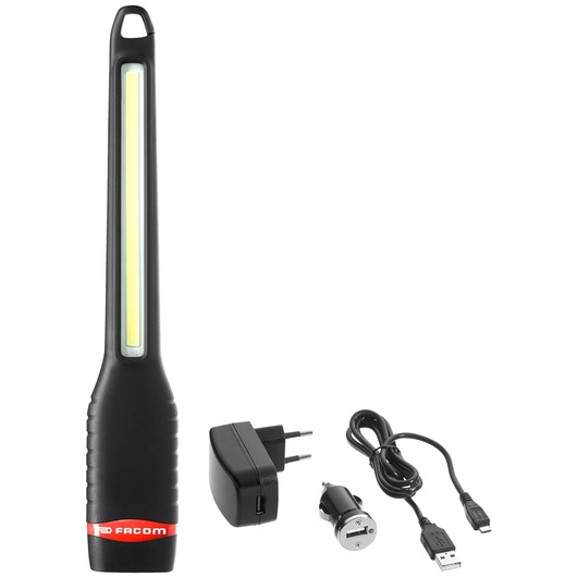 A black handheld LED work light with a Facom logo, accompanied by a power adapter, a car charger adapter, and a USB charging cable.