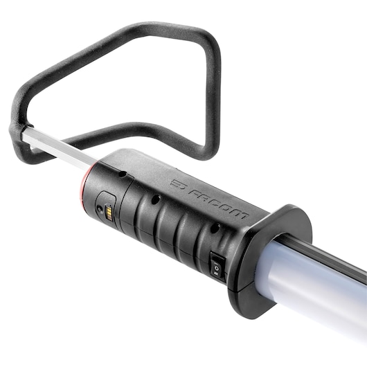 Facom 779_UHPB work light with black ergonomic handle, power switch, and protective guard, side angle on white.