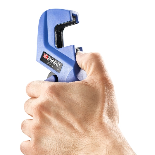 Photo of Facom 821416 pipe cutter in blue, held in hand, side view on white background.