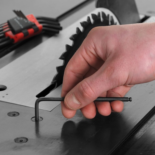 Photo of Facom 83SH_9 hex key in use, adjusting a machine bolt near a circular saw blade.