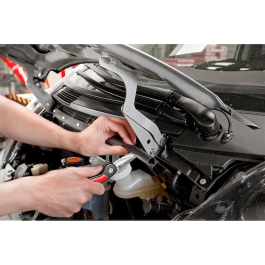 Facom 840.FPB pliers tool in use on car engine parts, close-up photography.
