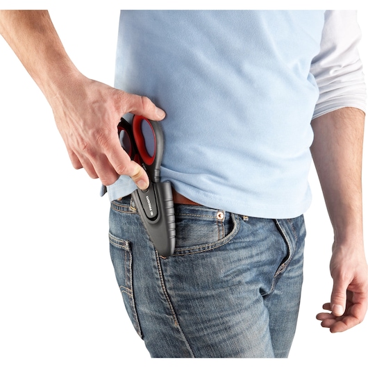 Photo of Facom 841A.3PB scissors with black and red handle being placed in a holster on jeans.