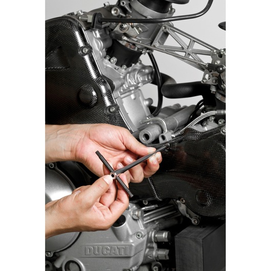 Facom 84TCD_3 T-handle hex key used for maintenance on motorcycle engine, close-up view.