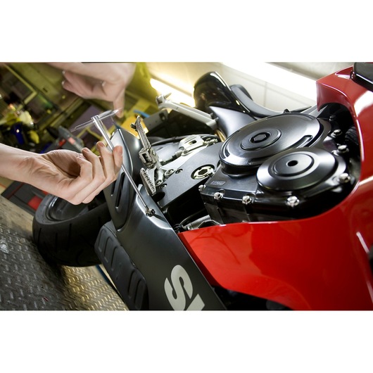 Facom 84TCD_8 T-handle hex key being used to adjust a motorcycle engine close-up.