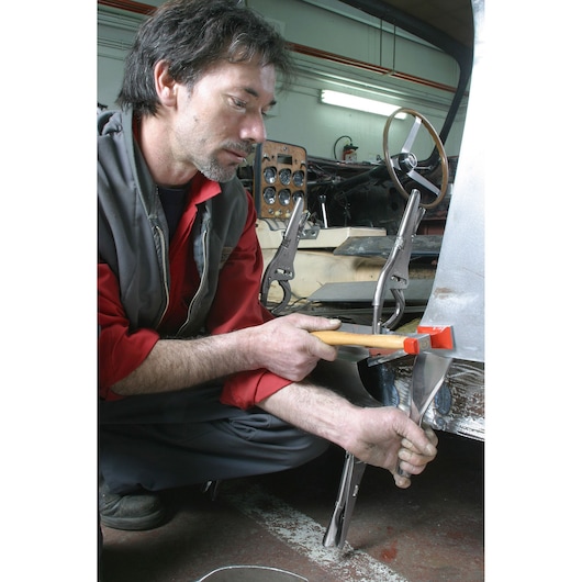 Facom 862D_60 metalworking clamp used on car body panel in workshop setting.