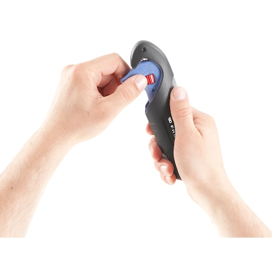 Close-up of two hands operating a Facom tool with a black and blue handle, adjusting a red dial.