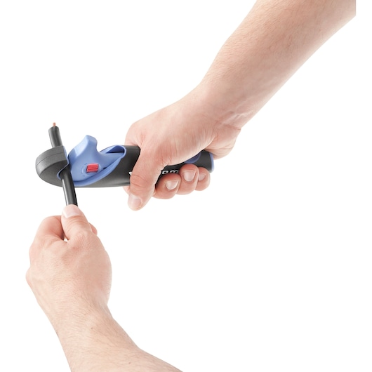 Facom 872271 wire stripper tool in use, black and blue handle, stripping insulation from a thick cable.