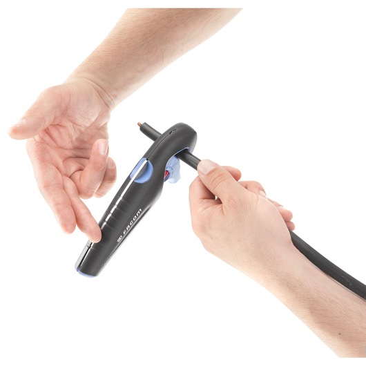 Photo of Facom 872271 cable stripping tool used on a wire, close-up with hands, on white background.