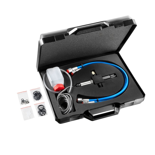Facom 900_DHP automotive diagnostic tool set with hoses, bottle, and O-rings in black hard case, top view.