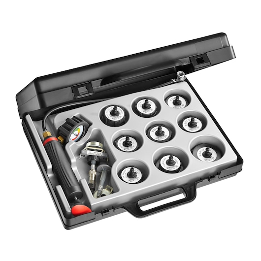 Facom 920B automotive cooling system pressure tester kit in black case, top angle, nine adapters visible.
