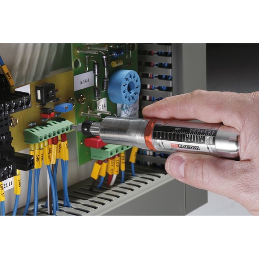 Facom A300MT torque screwdriver used on electrical circuit board, close-up photography.