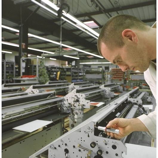 Facom A300MT torque screwdriver used for assembly on industrial machinery in a factory setting.