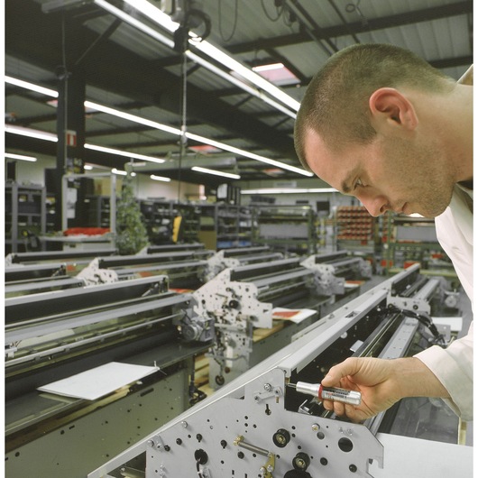 Photo of Facom A_301MT torque wrench being used to tighten a bolt on machinery in an industrial workshop.