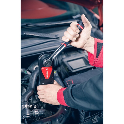 Facom AXS.LPB ratchet wrench in use near a car engine, close-up photography.