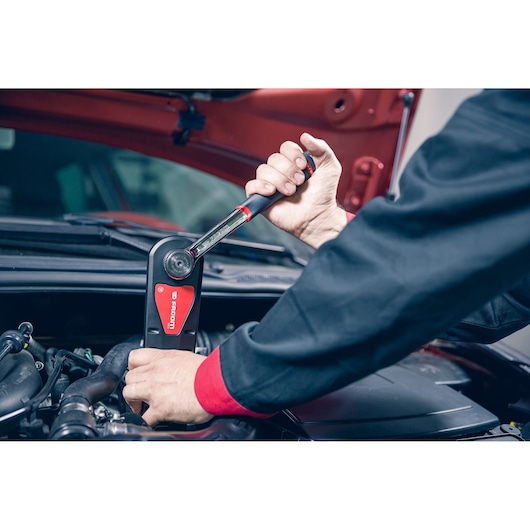 Photo of Facom AXS.SPB torque wrench used by mechanic working in a car engine bay.