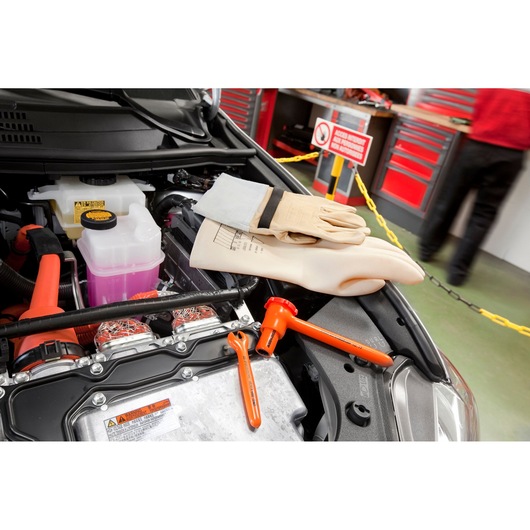 Facom BC_90VSE insulated gloves and tools on a car engine in a workshop setting.
