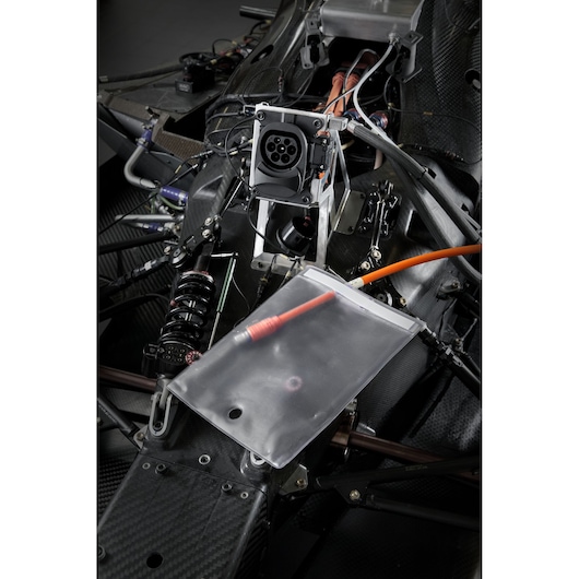 Facom BC.SACVE transparent document pouch on an electric vehicle chassis near orange power cables and components.