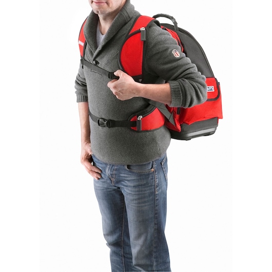 Photo of Facom BS.L30PB red and black backpack worn by a person, showing front and side strap details.