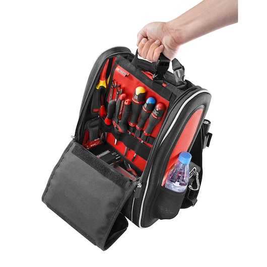Facom BS.MCBPB tool backpack with open front, red and black interior, holding assorted hand tools and a water bottle, front angle.