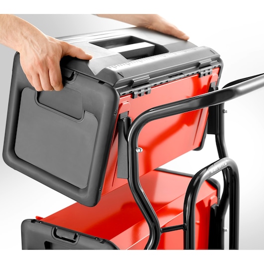 Facom BT200 tool box with black handle being placed on red cart, close-up side angle.