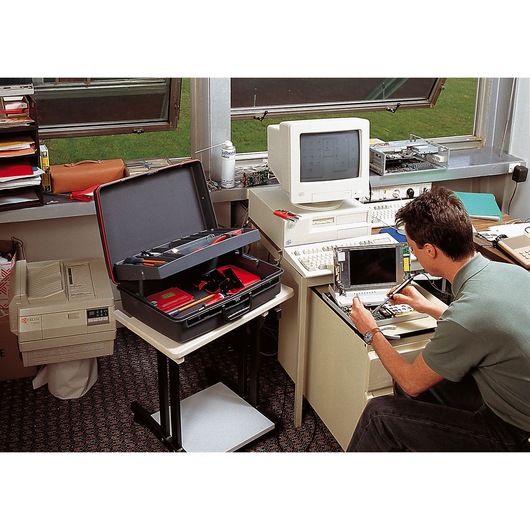 Facom BV_21ST open technician tool case with tools, on table in office workspace near computer.