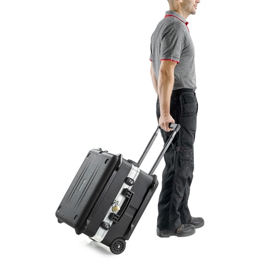 Facom BV61A rolling tool case with handle, black, side angle, being pulled by person.