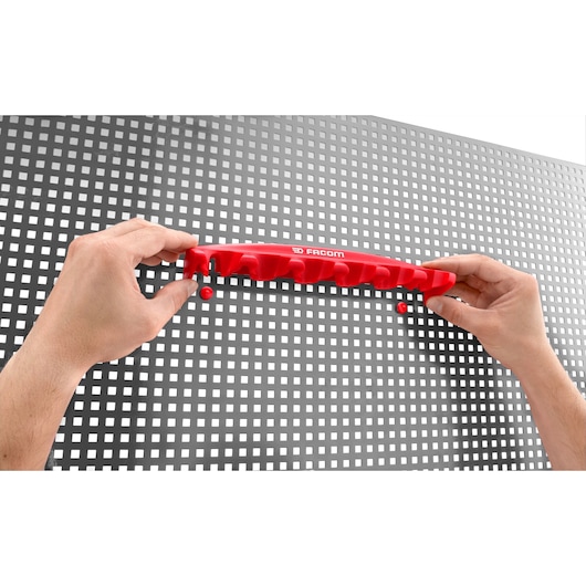 Facom CKS_08 red tool holder being mounted on perforated metal board, photography category.
