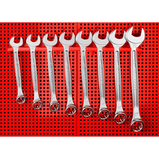 Photo of Facom CKS_101 combination wrenches set, seven chrome wrenches on red perforated background, front angle.