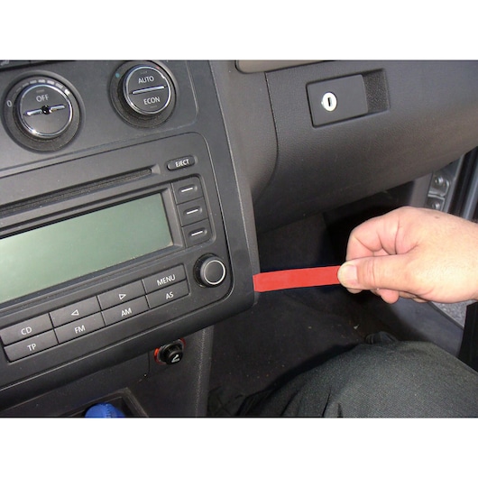 Facom CR.D5PB plastic trim removal tool used to pry a car dashboard panel.
