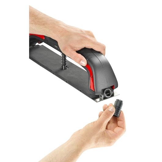 Facom CRSBL sander handle in black and red with a hand holding a removable attachment, white background, top angle.