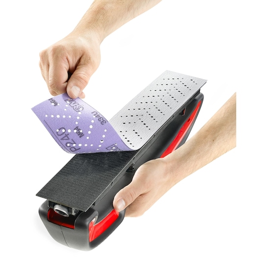 Facom CRSBL hand sanding block with red and black handle, close-up of user attaching perforated sanding sheet.