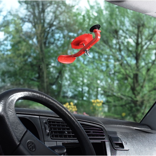 Facom DCR20J6 red auto tool attached to car windshield inside vehicle.