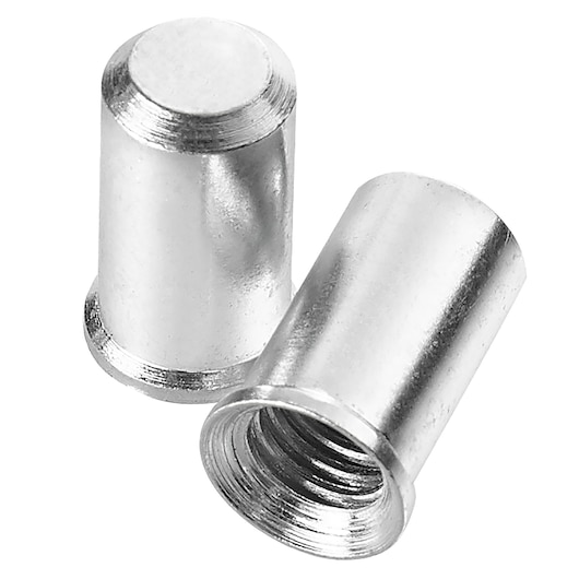 Close-up image of two metallic cylindrical threaded inserts, one standing upright and one lying on its side displaying the internal threading.